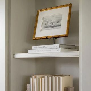 A picture frame on a stack of books