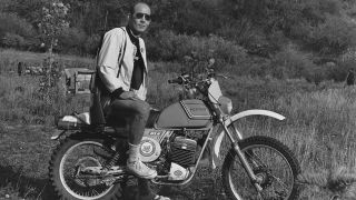 1976 image of Hunter S Thompson outside on his motorcycle.