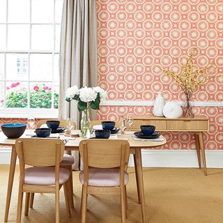 dining room with wallpaper and dining table