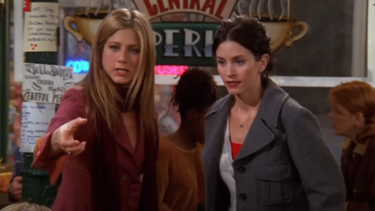 Rachel holding up her left hand and Monica looking forward on Friends. 