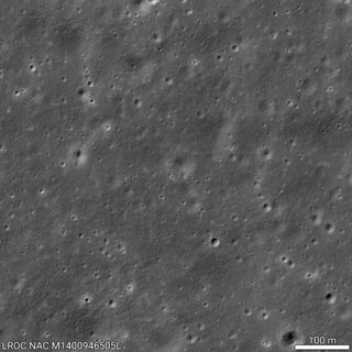 a chinese spacecraft is seen as a small white spot on the moon's gray, cratered far side