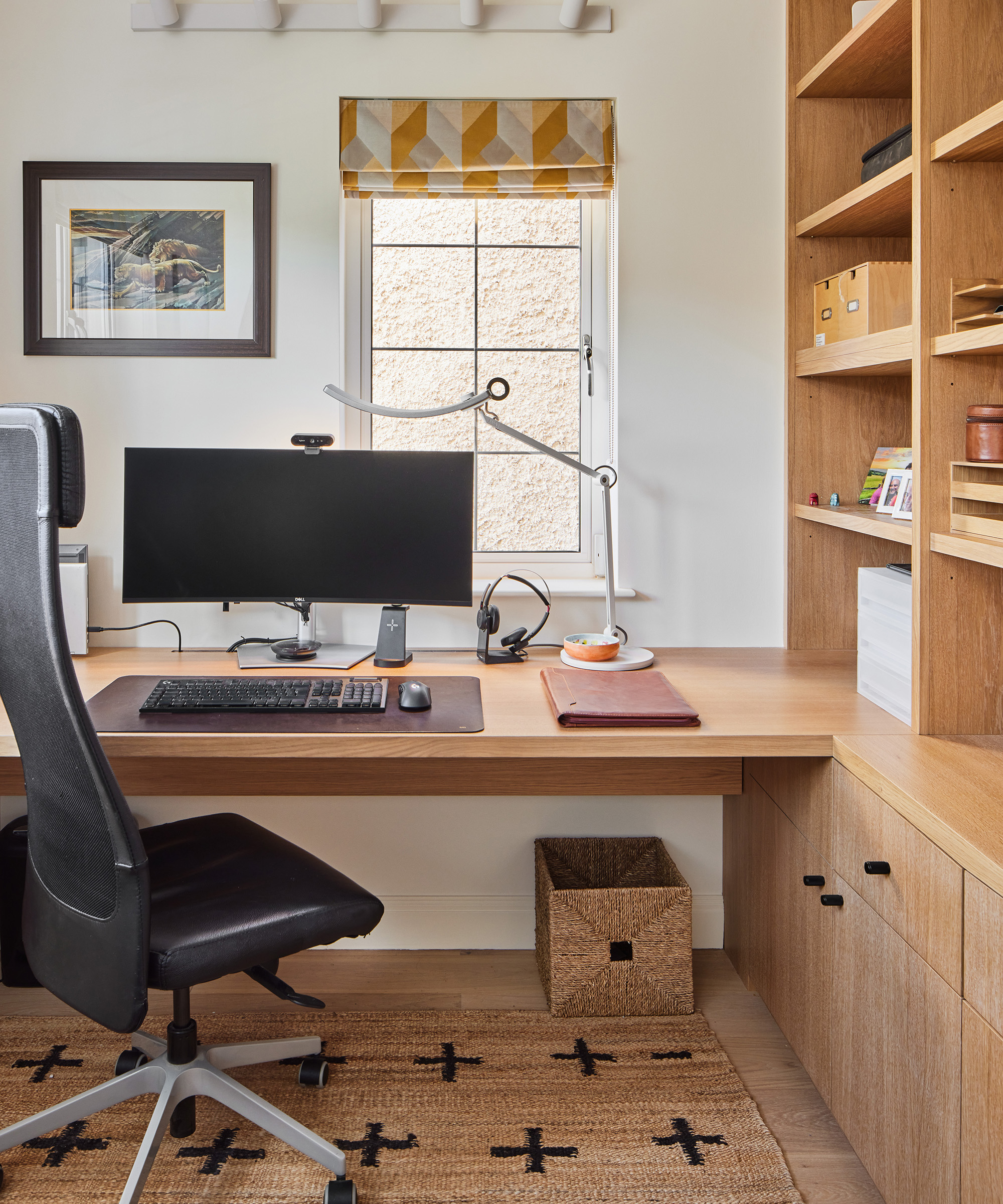 Small home office with built in cabinets and jute rug