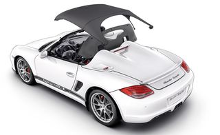 White sports car with the top unfolding