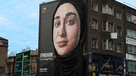 A mural advert for Gymshark featuring fitness influencer Leana Deeb wearing a headscarf