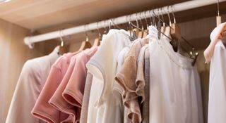 Clothing in neutral colours hanging on a clothes rail