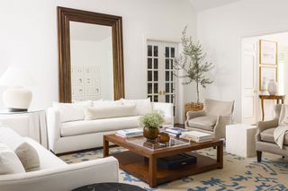 living room with white sofas and walls and wooden coffee table and vintage rug