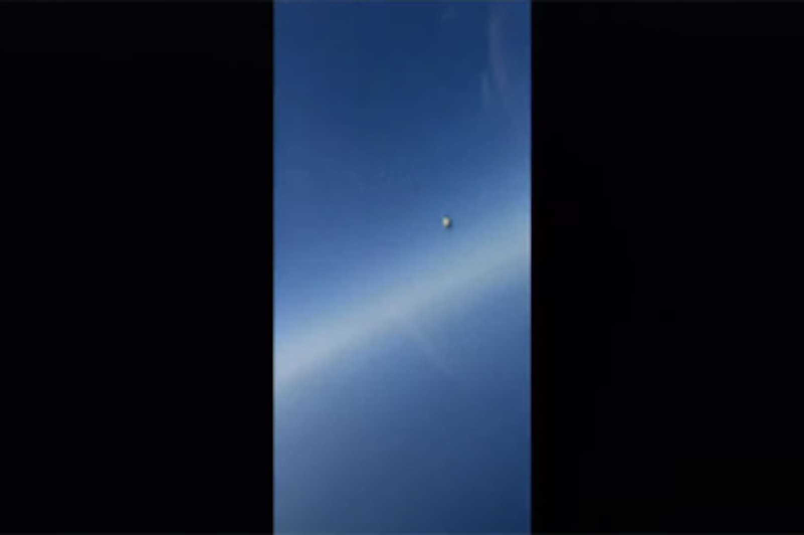 A seemingly metallic object can be seen as a tiny blip in split-second footage taken from aU.S. Navy pilot's cockpit.