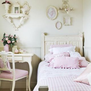 girl's bedroom with pink pillows and bedside table