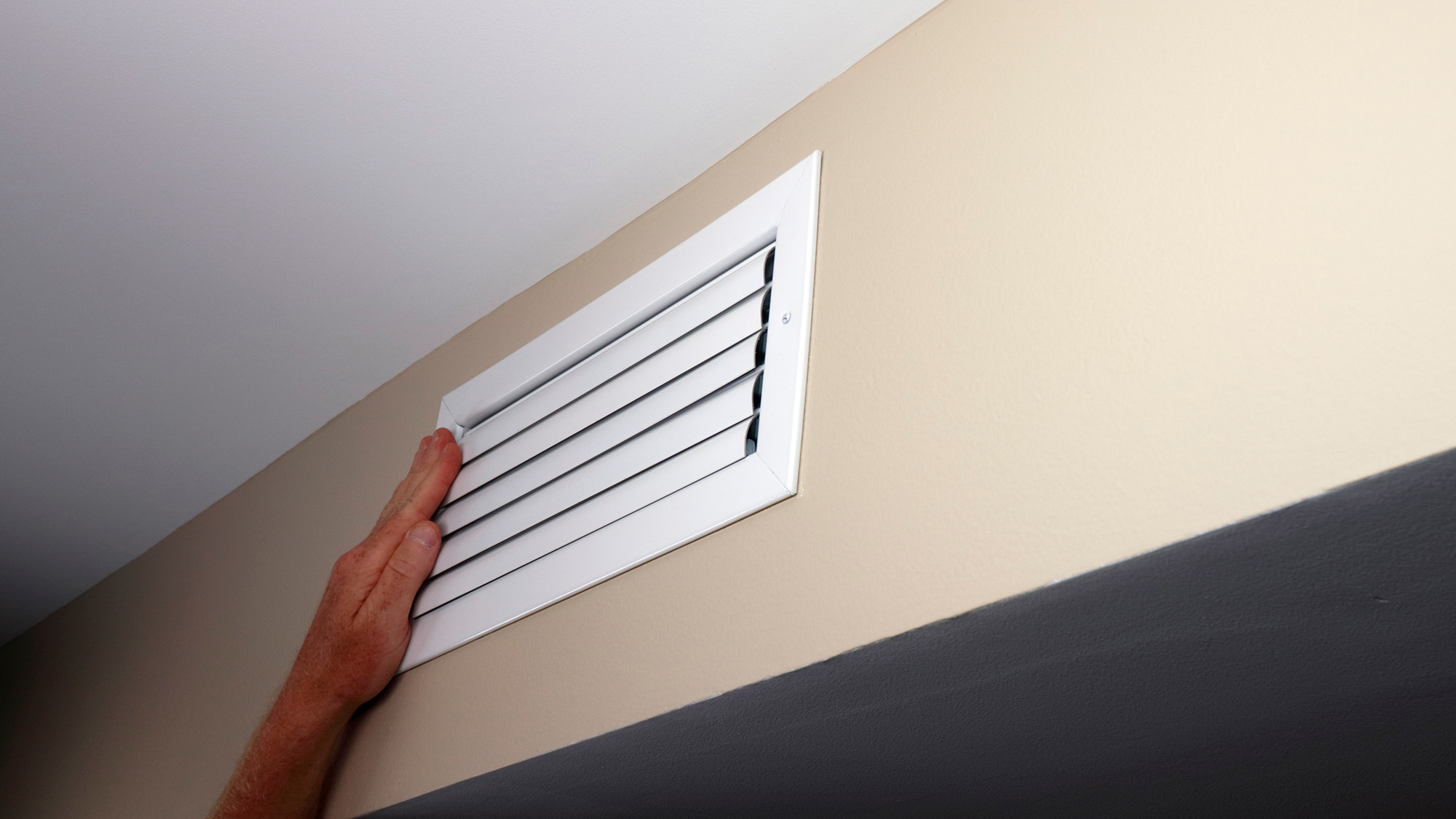 Man closing air vent