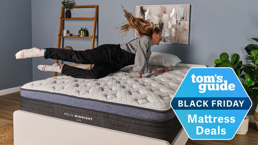 The Tom's Guide Sleep Editor jumping on a Helix mattress with a Tom's Guide Black Friday Mattress Deals badge overlaid
