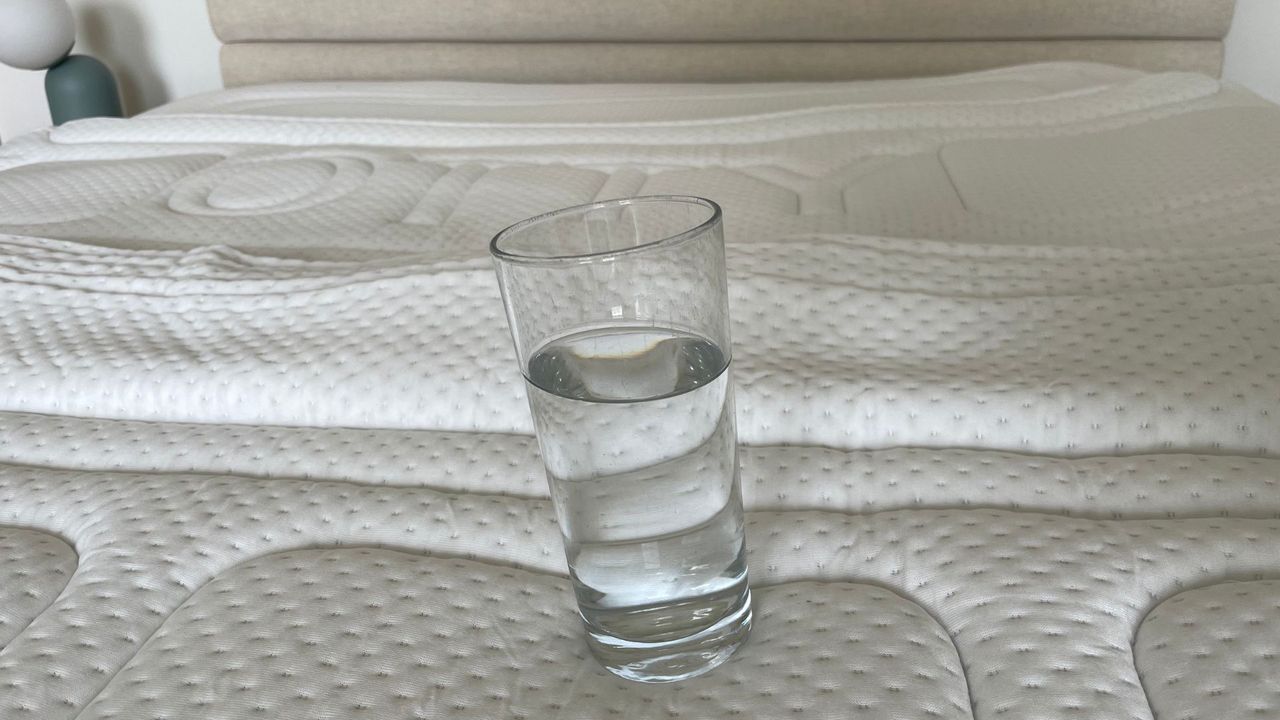 A glass of water on the OTTY Memory Foam Mattress Topper