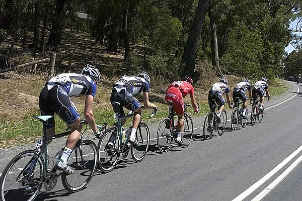 A single Drapac Porsche rider is surrounded by Jayco/Skins riders