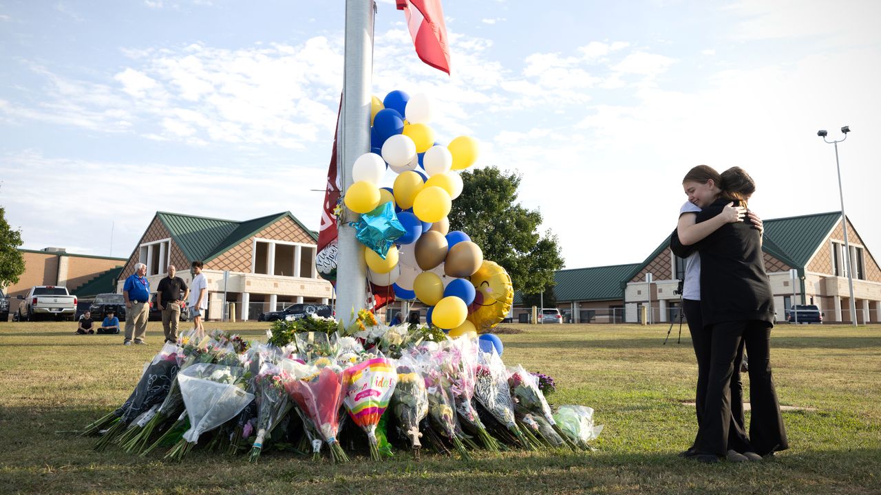 Mourners hug outside Apalachee High School in Winder, Georgia, after school shooting