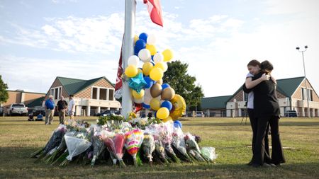 Mourners hug outside Apalachee High School in Winder, Georgia, after school shooting