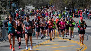 Runners begin to race up Heartbreak Hill in the 2022 Boston Marathon