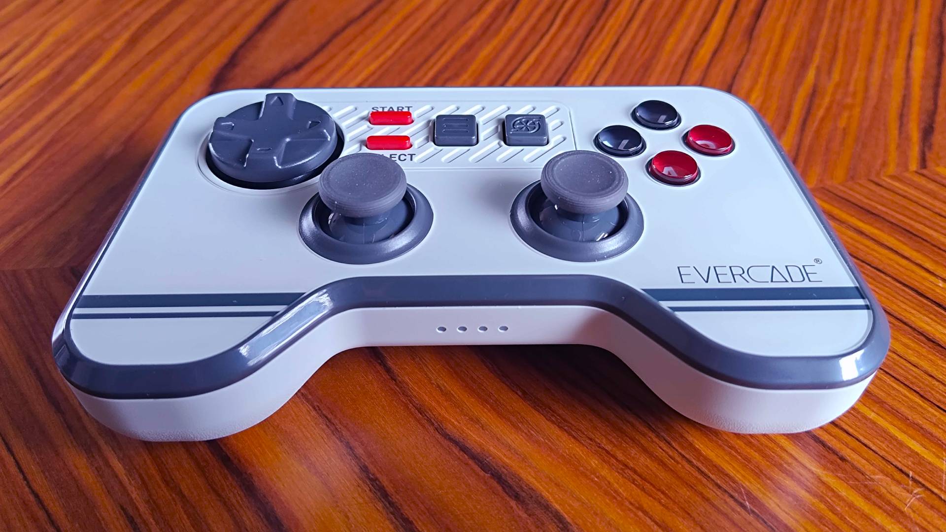 Evercade Dual Thumbstick Wireless Controller on woodgrain table.