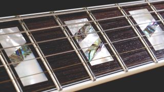 Close up shot of a guitar's fretboard