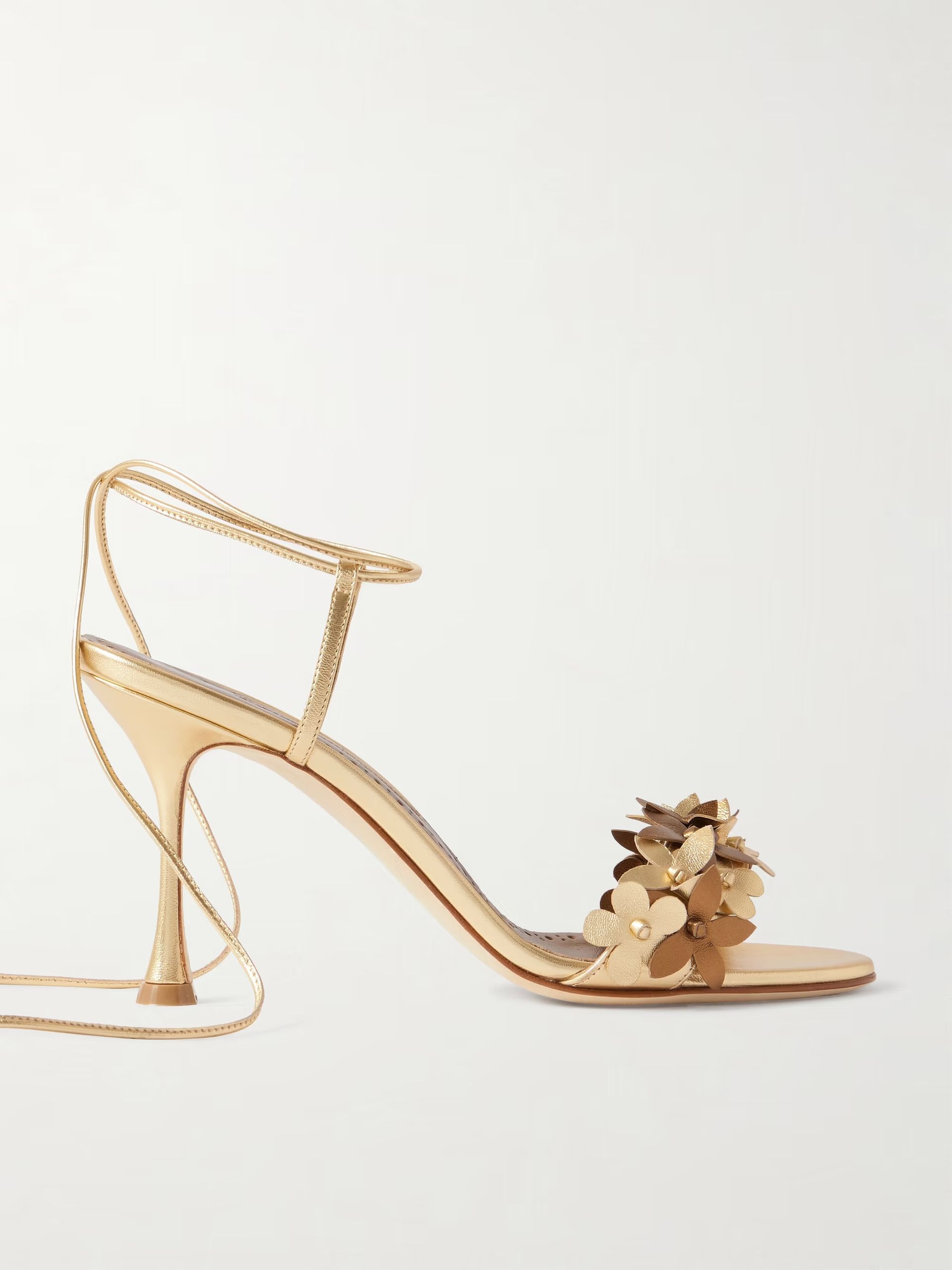A gold strappy heel with floral appliques