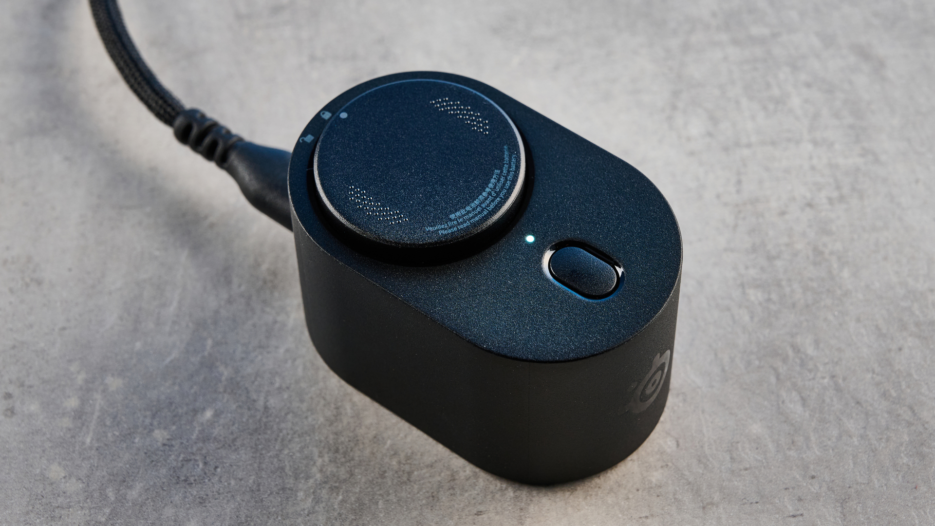 The SteelSeries Rival Pro mouse on a grey stone surface