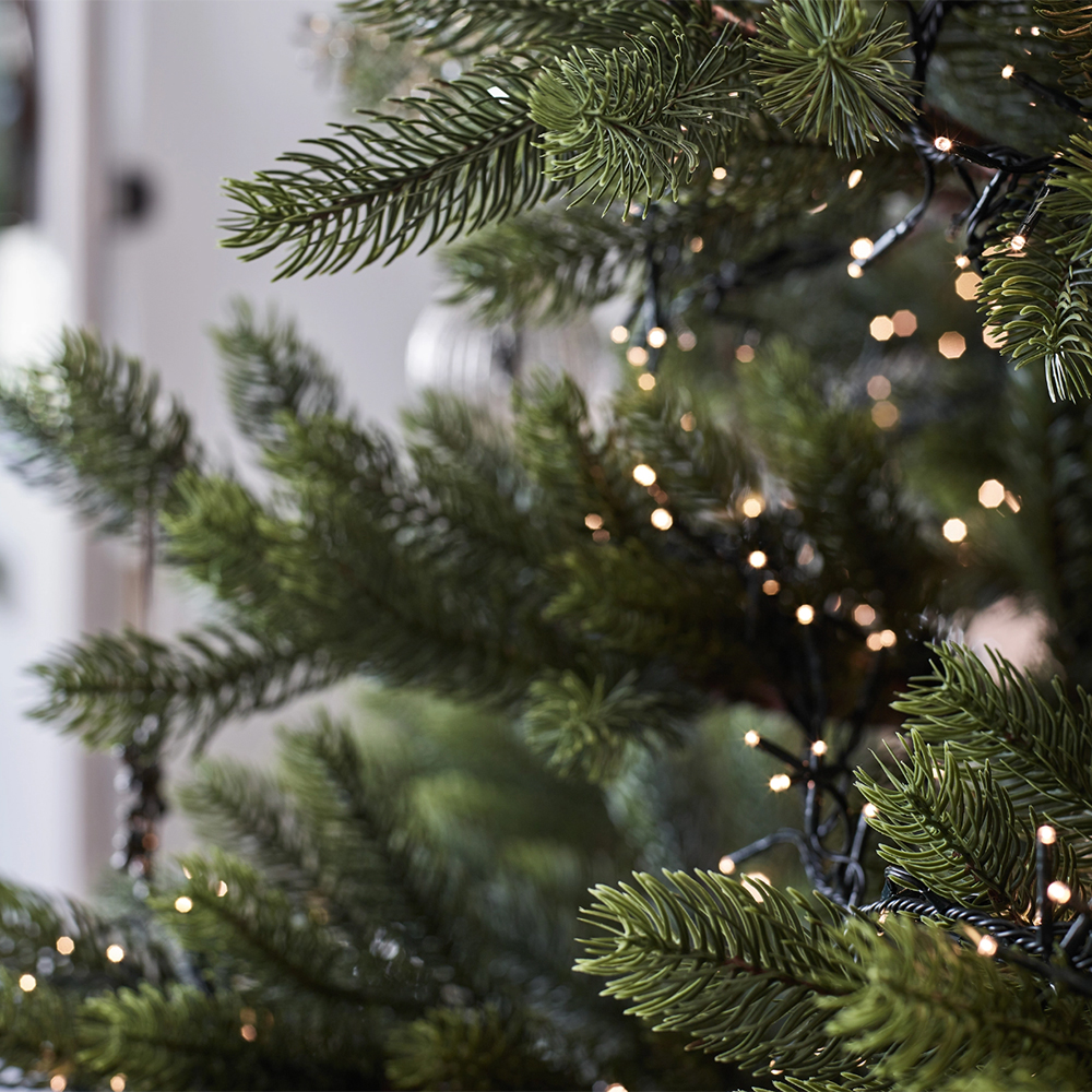 Close up of a Christmas tree with warm lights