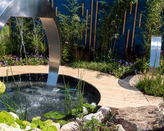 arched water feature at 'Petrus: Full Circle', designed by Rachael Bennion, in partnership with service users and volunteers at homelessness charity Petrus Community, at RHS Flower Show Tatton Park 2021
