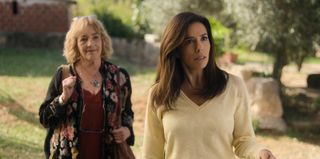 A still from Land Of Women episode 2 showing Julia (Carmen Maura) and Gala (Eva Longoria) standing outside, with a garden visible in the background