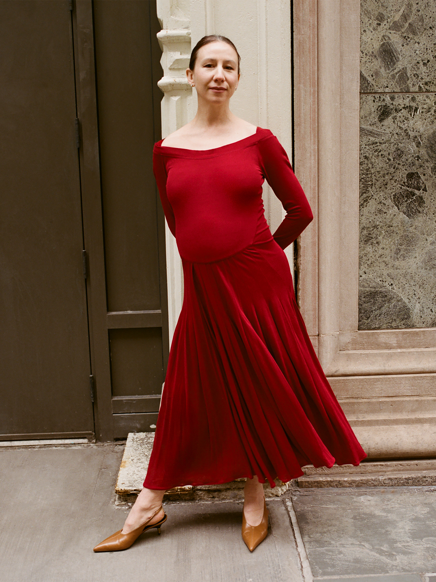 Isabella Boylston poses outside in a red dress.