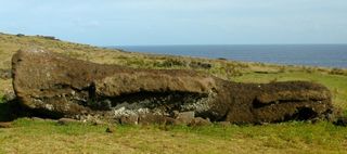 a fallen moai or statue from easter island