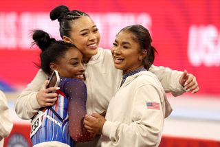 Simone Biles, Suni Lee, and Jordan Chiles hug during the Olympic Team Gymnastics Trials on June 30, 2024.