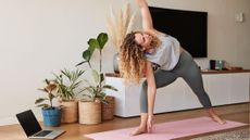 Woman practicing yoga at home