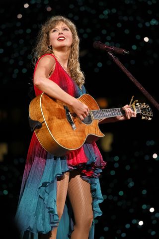 Taylor Swift wears a Roberto Cavalli tricolor dress onstage at the Eras Tour