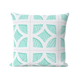 A turquoise and white printed throw pillow