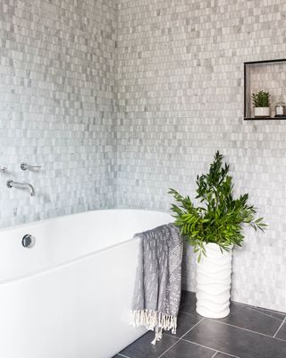 gray bathroom wall tiles and floor tiles, white tub