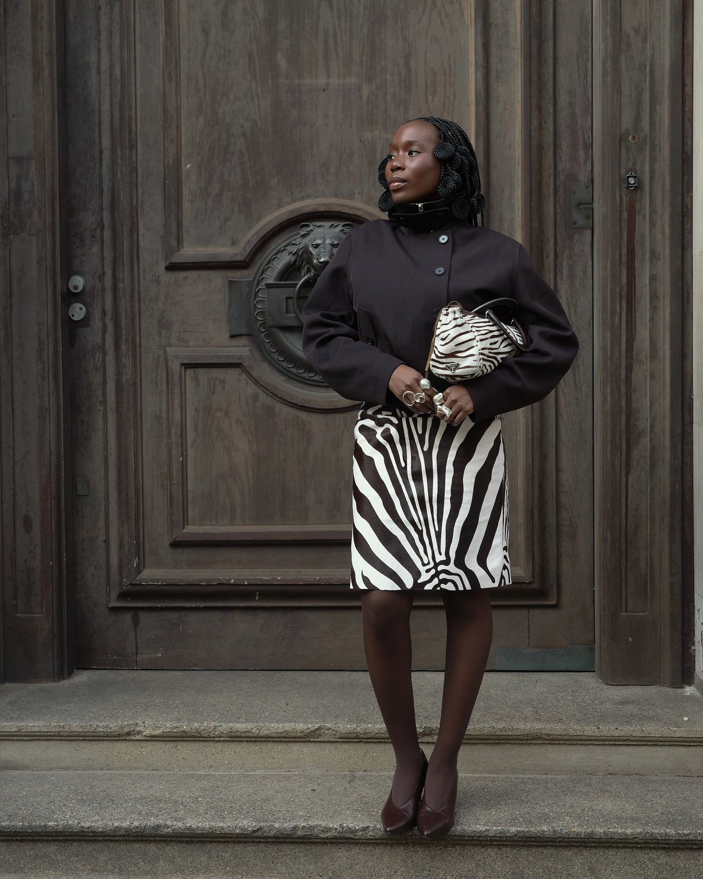 Fashion person daniellejinadu wears the zebra print skirt trend. She wears a zebra print skirt, funnel neck jacket and zebra print bag. This image was taken from her Instagram.