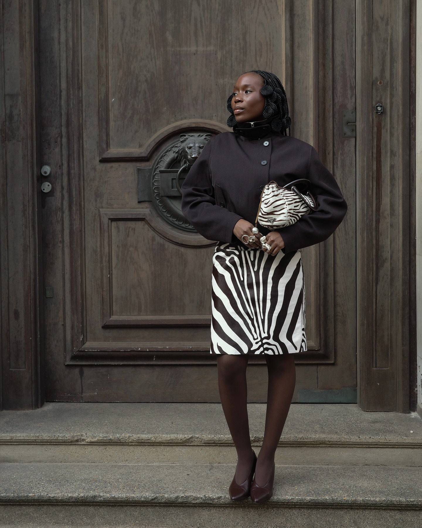 Fashion person daniellejinadu wears the zebra print skirt trend. She wears a zebra print skirt, funnel neck jacket and zebra print bag. This image was taken from her Instagram.
