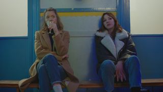 Julia (Anna Maxwell-Martin) and Liz (Diane Morgan) sitting down in a school in Motherland