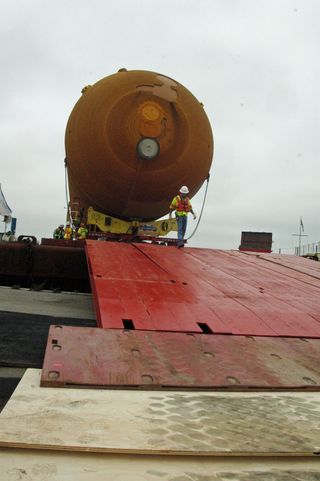 ET-94 preparing to be towed down the steel and wooden ramp between the transport barge and dockside.