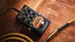 Electro-Harmonix Bender Royale &ndash; the feature-packed fuzz pedal is finished in a black enclosure with orange graphics/text, and is photographed here in warm tones against a wooden background.