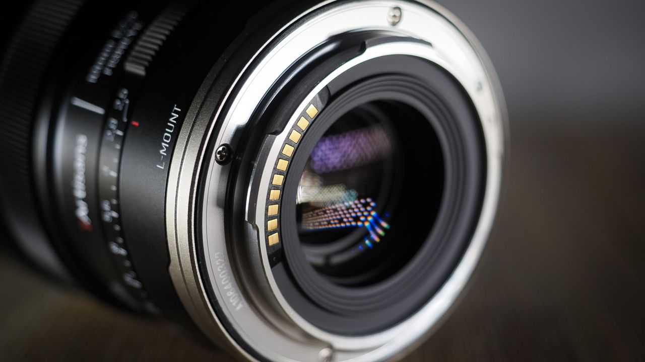 7Artisans AF 10mm f/2.5 Fisheye Max lens on a wooden surface