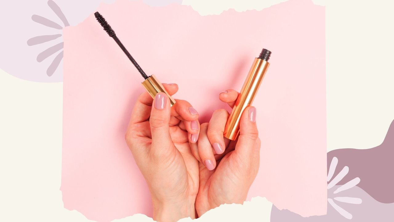 A woman&#039;s hand holding a mascara tube and wand learning how to apply mascara