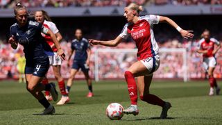 Chloe Kelly of Arsenal takes on Maya Le Tissier of Manchester United during the Barclays Women's Super League match between Arsenal FC and Manchester United FC at Emirates Stadium on May 10, 2025 in London, England.