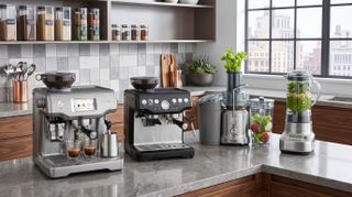 A selection of Breville kitchen appliances arranged on a kitchen counter.