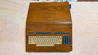 A top down view of a customized computer built in 1982 with a keyboard built into the wooden frame.