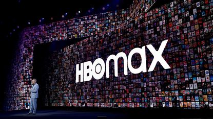 An HBO Max sign is shown in the background during an AT&T investor presentation