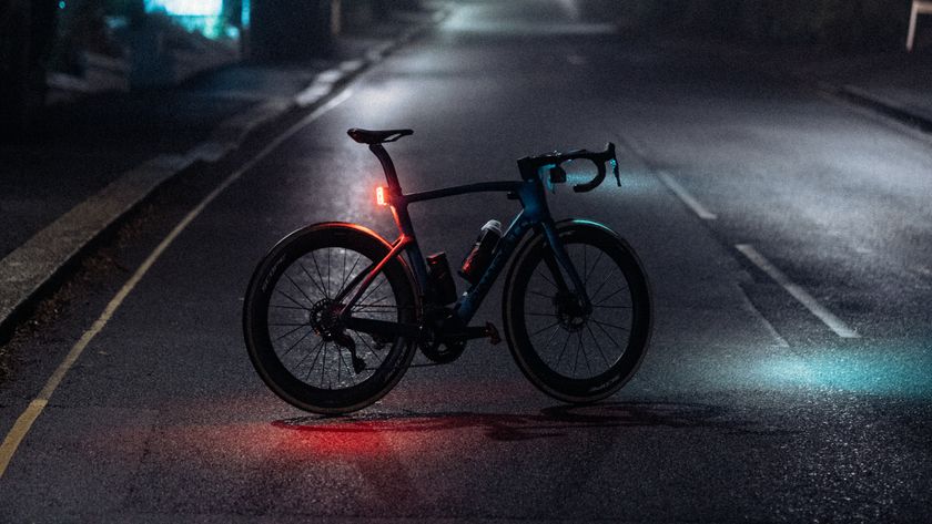 Pinarello Dogma with bright bike lights at night