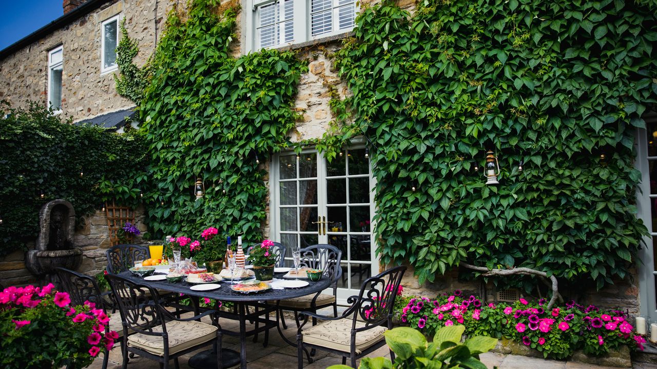 A country home with patio and ivy growing up walls