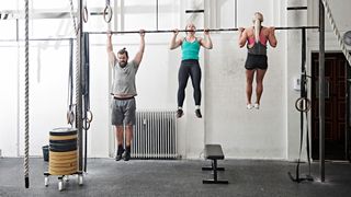 Three people doing pull-ups