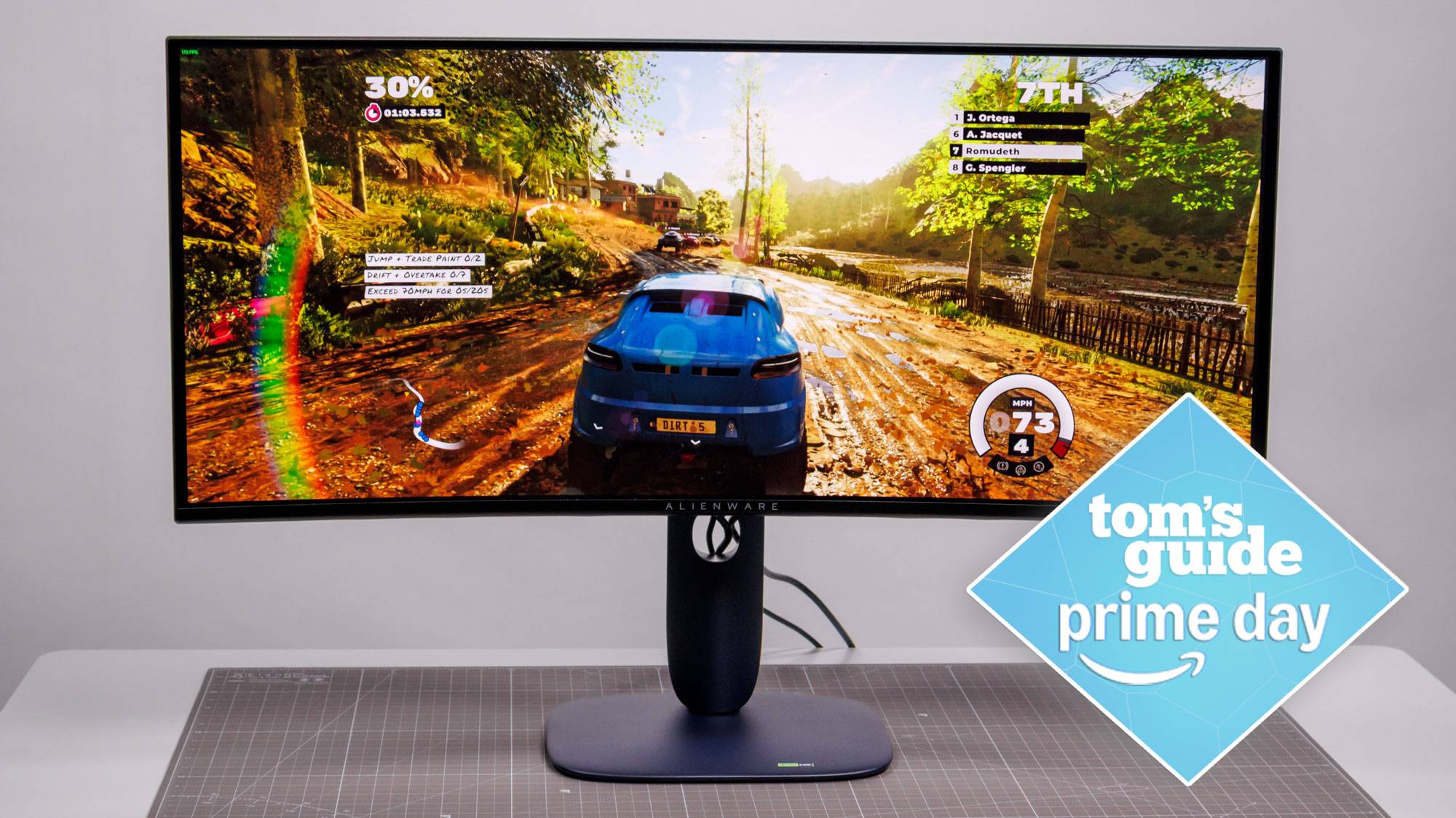 Alienware AW3425DW on table with car game on display with Tom&#039;s Guide Prime Day badge
