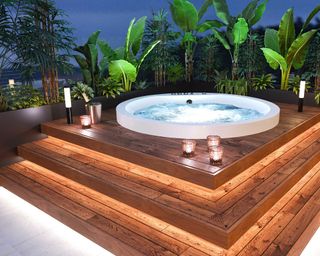 hot tub with raised deck and lighting