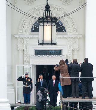 President Barack Obama salutes as he and U.S. Senator Charles Ellis "Chuck" Schumer (D-NY) depart the White House for Capitol Hill and the swearing-in of Obama as the nation's 44th President, Monday, Jan. 21, 2013, in Washington, DC.
